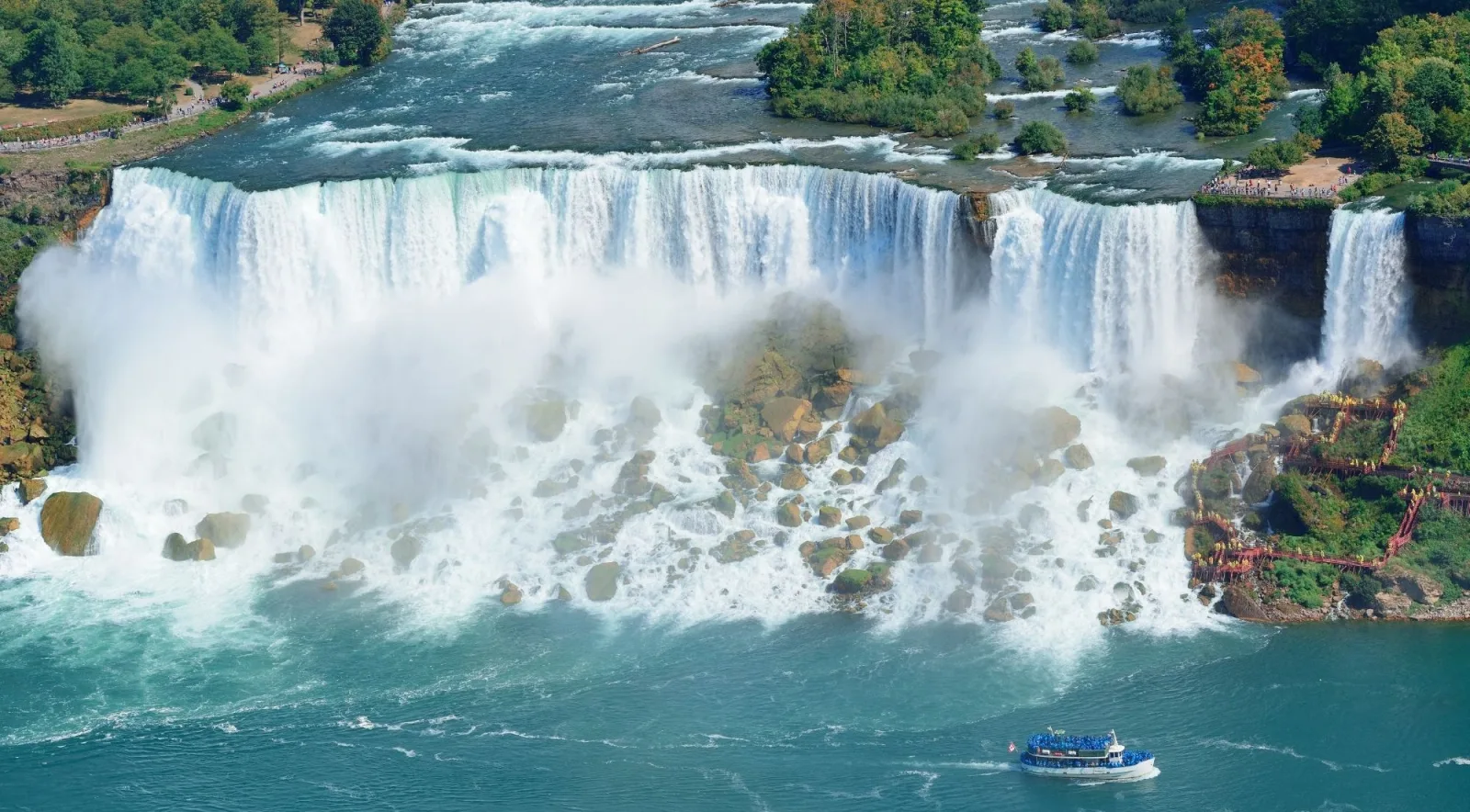 Aerial view of the American and Bridal Veil Falls with a tour boat crossing the water below